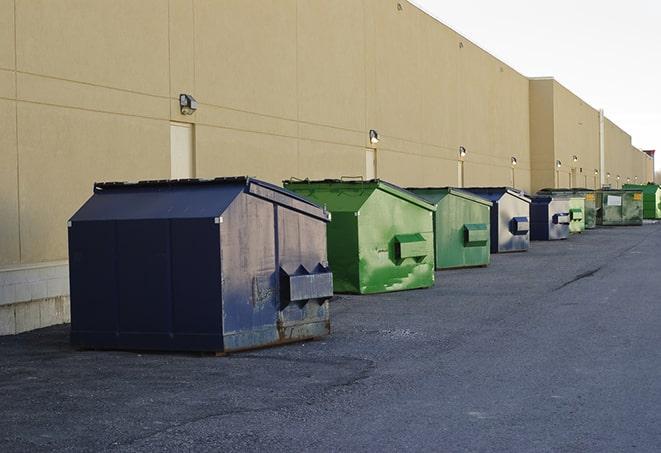 a view of a dumpster truck on a construction site in Amityville, NY